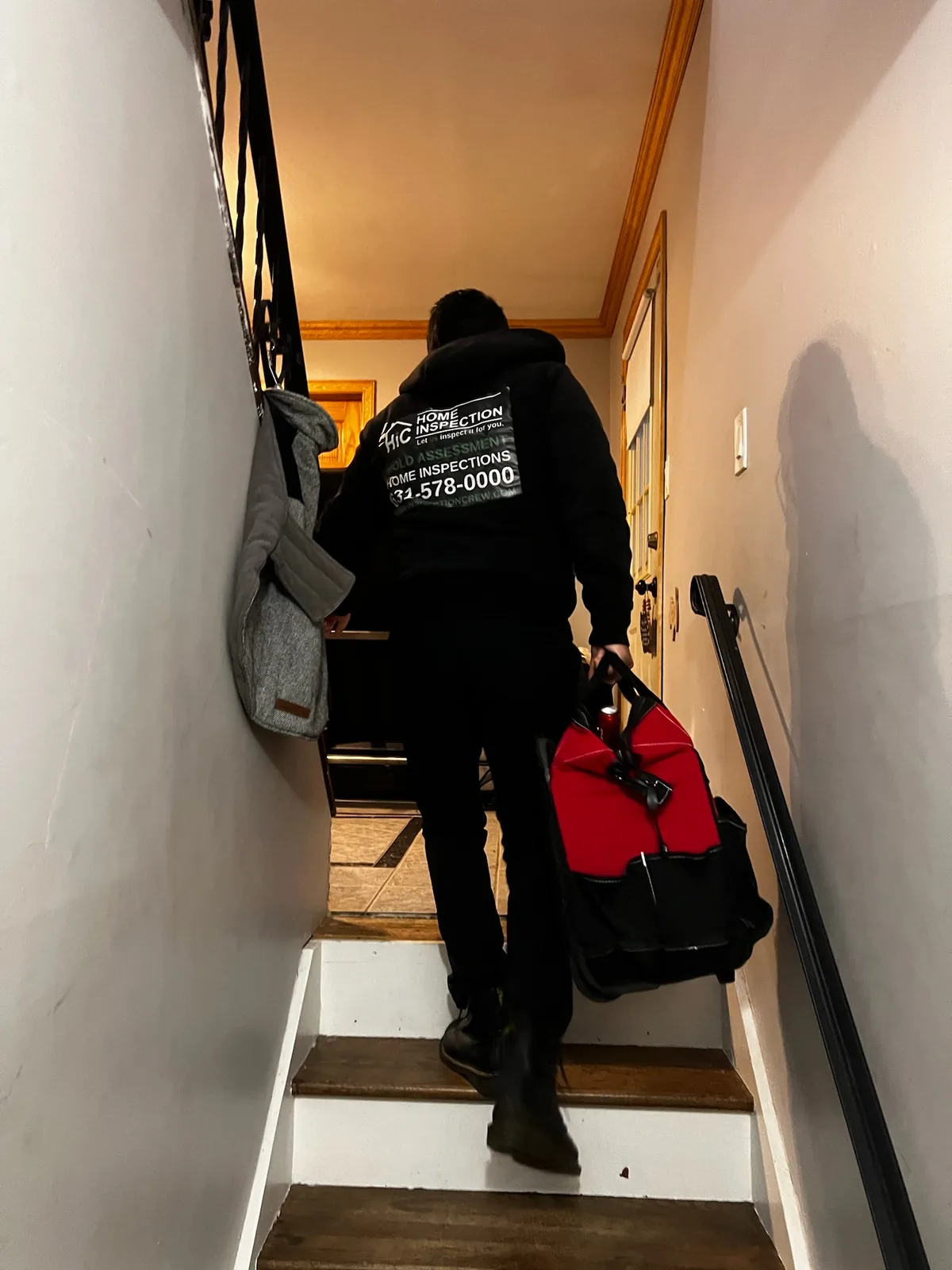 Home Inspection Crew inspector carrying inspection equipment into a property