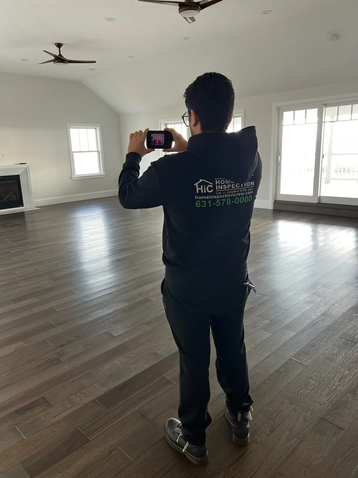 Home Inspection Crew inspector using thermal imaging equipment during a residential inspection